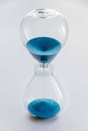 Foto de Reloj de arena azul aislado sobre fondo blanco. Concepto de paso del tiempo - Imagen libre de derechos