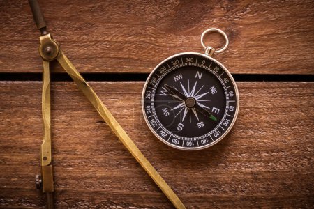 Photo for Vintage drawing and navigational Compass on a rustic wooden board - Royalty Free Image