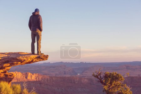 Photo for Man on the mountains cliff at sunrise. Hiking scene. - Royalty Free Image