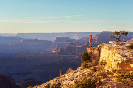Photo for Traveler on cliff mountains over Grand Canyon National Park, Arizona, USA.Inspiring emotion. Travel Lifestyle journey success motivation concept adventure  vacations outdoor concept. - Royalty Free Image