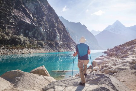 Photo for Hiker admires the lake  Paron in Cordillera Blanca,  Peru, South America - Royalty Free Image
