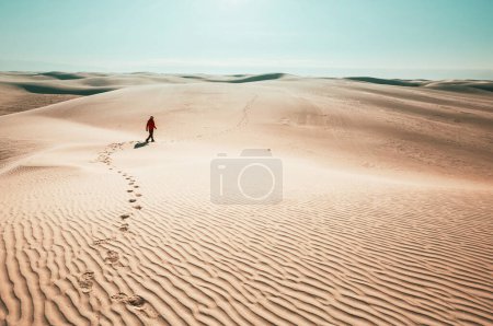 Photo for Hiker among sand dunes in the desert - Royalty Free Image