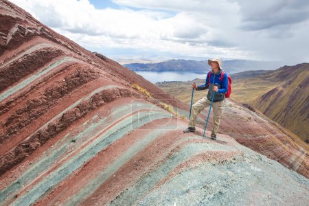 Photo for Hiker in Pallay Poncho, alternative Rainbow mountains - Royalty Free Image
