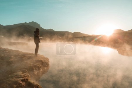 Photo for Tourist looking on Natural Hot Spring in  Atacama desert, Chile, South America. - Royalty Free Image