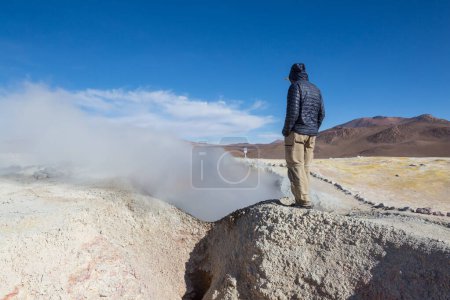 Photo for Tourist in the area Geyser Sol de Manana, Bolivia. Beautiful unusual natural landscapes in South America. - Royalty Free Image