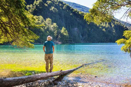 Photo for A man is resting at ease by the calm lake. Relaxation vacation - Royalty Free Image