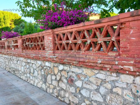 Foto de The old fence wall of vintage brick decorated - Imagen libre de derechos