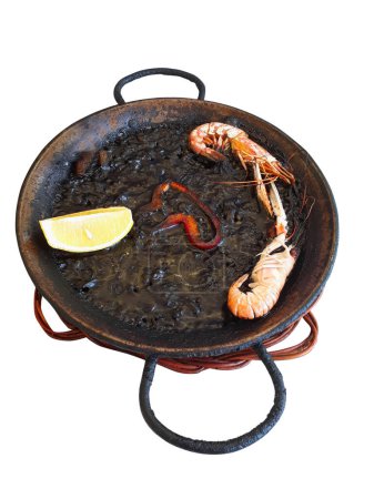Photo for Spanish black squid ink paella with lobsters and scallops isolated on white. Classical Spanish cuisine - Royalty Free Image