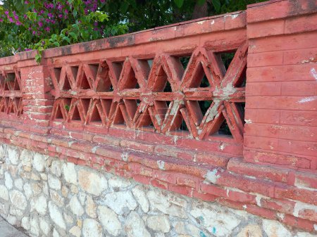 Foto de The old fence wall of vintage brick decorated - Imagen libre de derechos