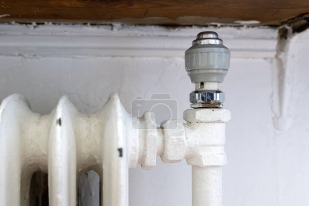 Photo for Old cast iron household heating radiator in living room - Royalty Free Image