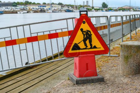 Photo for Road works sign on Nissan river promenade in Halmstad, Sweden. Selective focus. - Royalty Free Image