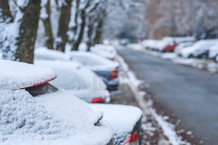 Photo for Cars under first snow of the winter on parking lot in residential district, selective focus - Royalty Free Image