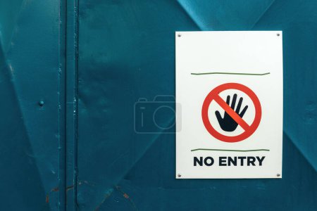 Photo for No entry sign with Stop hand gesture on fence - Royalty Free Image