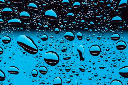 Foto de Water drops on window glass surface as abstract background - Imagen libre de derechos