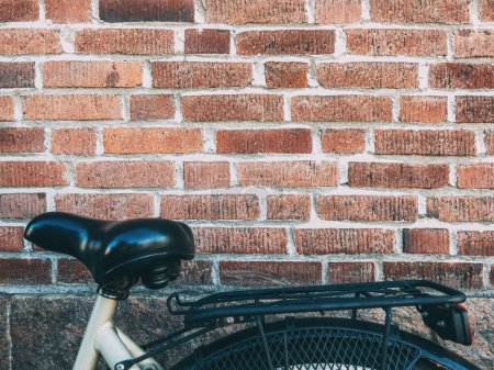 Photo for Bicycle seat leaning on to brick wall in Halmstad, Sweden - Royalty Free Image