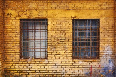 Photo for Old grid windows with dirty glass on exterior wall of an old abandoned factory warehouse building - Royalty Free Image