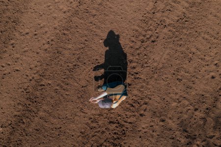Téléchargez les photos : Aerial view of female farmer agronomist inspecting the quality of plowed field soil before seeding, top down drone pov - en image libre de droit