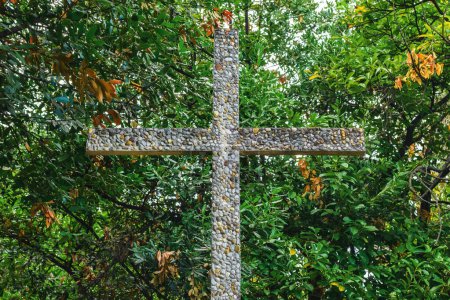 Photo for Religious cross made of cement and pebbles in park - Royalty Free Image