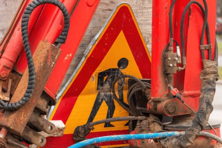 Photo for Damaged road works traffic sign and industrial equipment, selective focus - Royalty Free Image