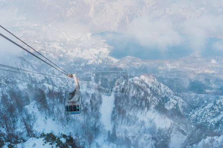 Photo for Bohinj, Slovenia - February 19, 2023: Cable car gondola to mountain Vogel, famous ski resort in Slovenian national park Triglav - Royalty Free Image