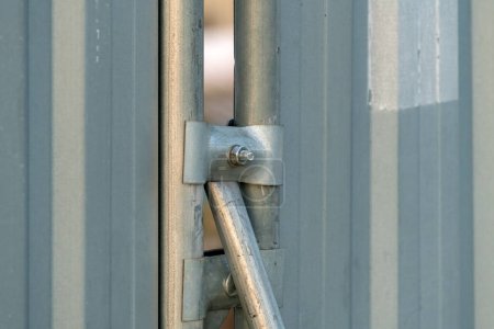 Photo for Construction site fencing hoarding panels and back support pipe, selective focus - Royalty Free Image