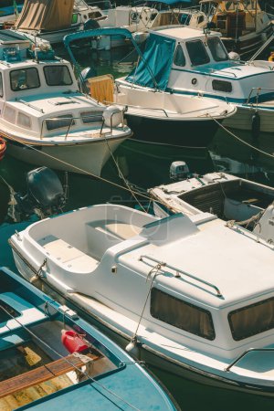 Téléchargez les photos : Fishing dinghy boats moored in small marina in town of Lovran, Croatia. Selective focus. - en image libre de droit