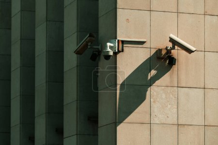 Photo for Old worn surveillance security cameras mounted on building wall, selective focus - Royalty Free Image