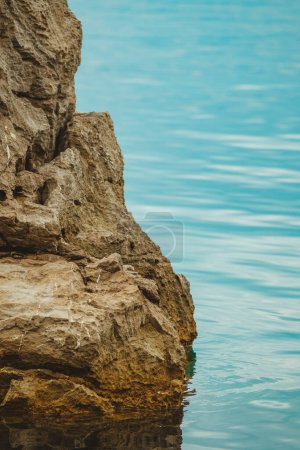 Photo for Kvarner gulf of Adriatic sea rocky coastline, large rocks at shoreline in old town of Lovran in Croatia. Selective focus. - Royalty Free Image
