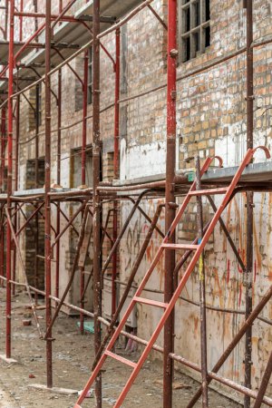 Photo for Scaffolding structure on construction site, renovation of an old industrial building, selective focus - Royalty Free Image
