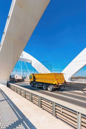 Photo for Truck with tipper semi trailer crossing the bridge, selective focus - Royalty Free Image