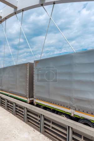 Photo for Semi-truck trailers with tarp cover on the bridge, transport and business concept - Royalty Free Image