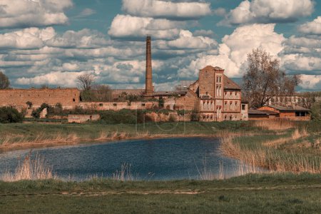 Photo for Old ruined factory building at lakeside on sunny spring day, selective focus - Royalty Free Image