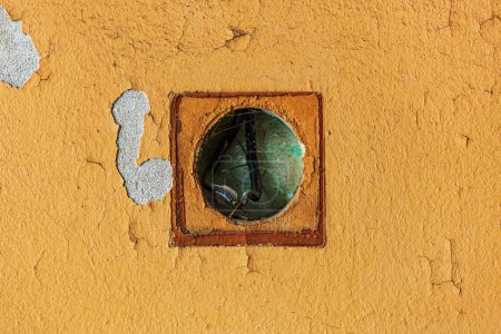 Photo for Round pan electrical box fixture on and old wall as background - Royalty Free Image