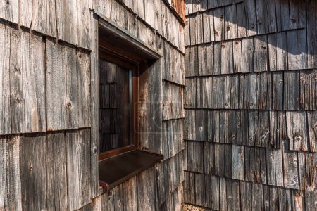 Téléchargez les photos : Fenêtre de chalet de montagne slovène et façade carrelée en bois usé, foyer sélectif - en image libre de droit