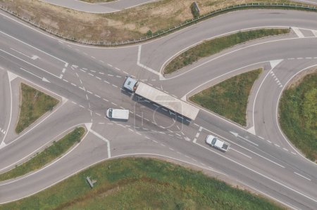 Photo for Aerial shot of large semi-truck, a van and a pickup truck on road intersection from drone pov, directly above - Royalty Free Image