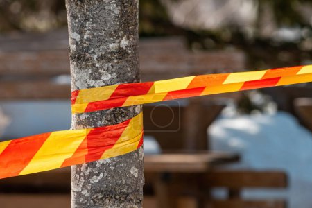 Photo for Red and yellow caution tape as a warning and marking of protected area, selective focus - Royalty Free Image
