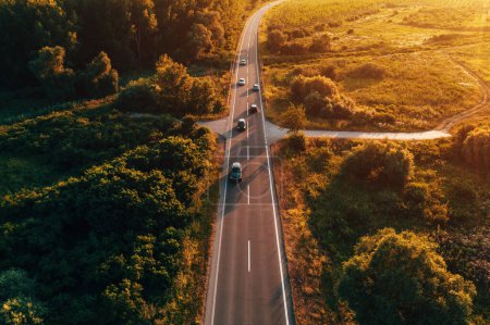 Photo for Countryside road with many cars in sunset, aerial shot from drone pov high angle view - Royalty Free Image