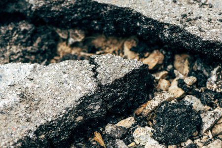 Photo for Closeup of cracked asphalt concrete road with selective focus - Royalty Free Image