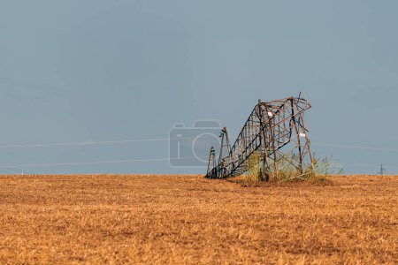 Photo for Bent over electricity pylon after strong summer storm, climate change consequences - Royalty Free Image