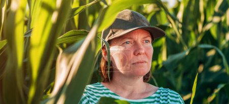 Photo for Headshot portrait of female farm worker in cultivated corn crop field, selective focus - Royalty Free Image