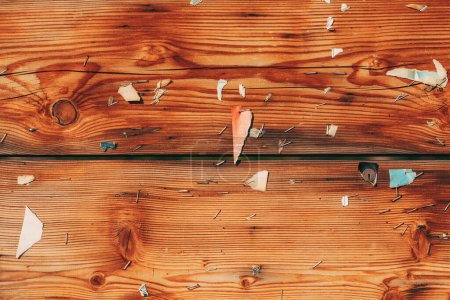 Photo for Worn wooden board with paper and staple ammo as background - Royalty Free Image