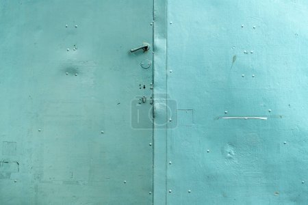 Photo for Old handle on worn metallic gate with scratched surface - Royalty Free Image