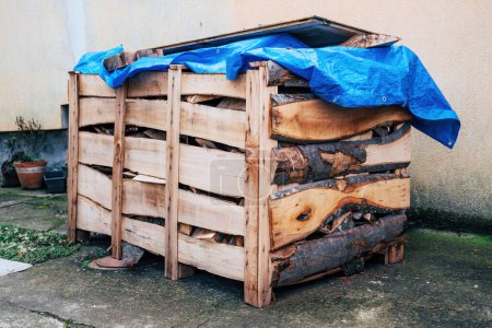 Photo for Stacked firewood in wooden crate box, - Royalty Free Image