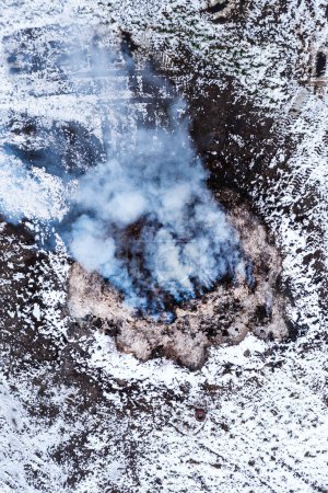 Photo for Burning manure pile at farm, air pollution and contamination, aerial shot from drone pov, high angle view - Royalty Free Image