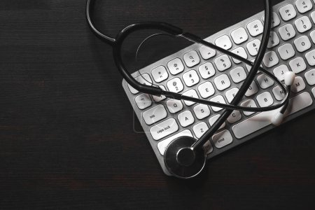 Photo for Stethoscope and computer keyboard on doctor's desk, high angle view - Royalty Free Image