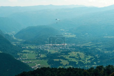 Photo for Paragliding over Lake Bohinj valley in summer, selective focus - Royalty Free Image