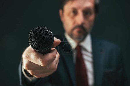 Photo for Journalist pointing microphone towards the view during interview, first person pov, selective focus - Royalty Free Image
