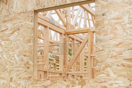 Prefabricated wooden house construction site, wood beam joists and wood chip boards, selective focus
