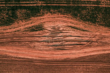 Photo for Drone pov aerial shot of country dirt road with mud and tractor tire tracks, top down - Royalty Free Image