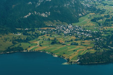 Aerial shot of Stara Fuzina, beautiful scenic alpine village in Lake Bohinj Valley in Slovenia, high angle view